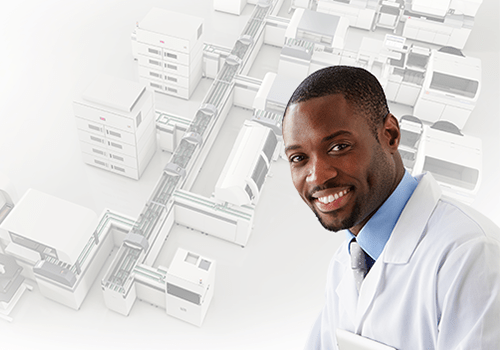 Laboratory Automation for All Webinar Young man in a medical laboratory coat smiling with the DxA 5000 Automation system in the background